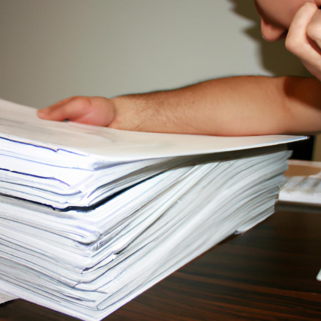 Person reading stack of documents